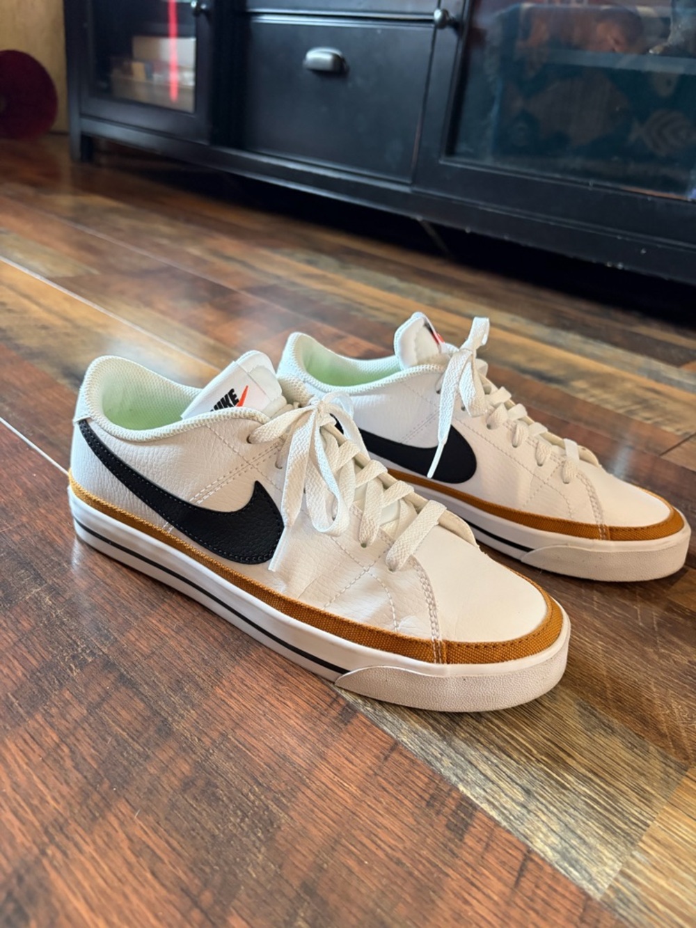Nike Sneakers with Black Swoosh and Gold Accent